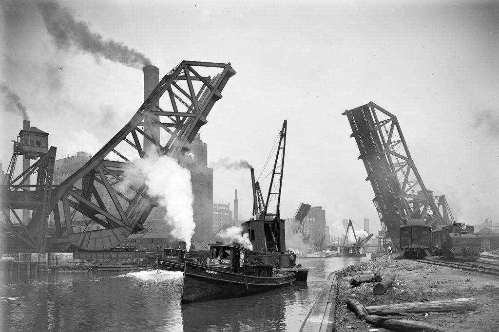 The A.B. Ward steamboat moves past the 12th St. Bascule Bridge on the Chicago River. This photograph was created sometime between 1890 and 1910