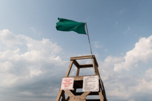 A green flag flying at the beach, the signal that indicates it is safe to swim in the lake when a lifeguard is present - Chicago Lakefront photography by Michael Courier